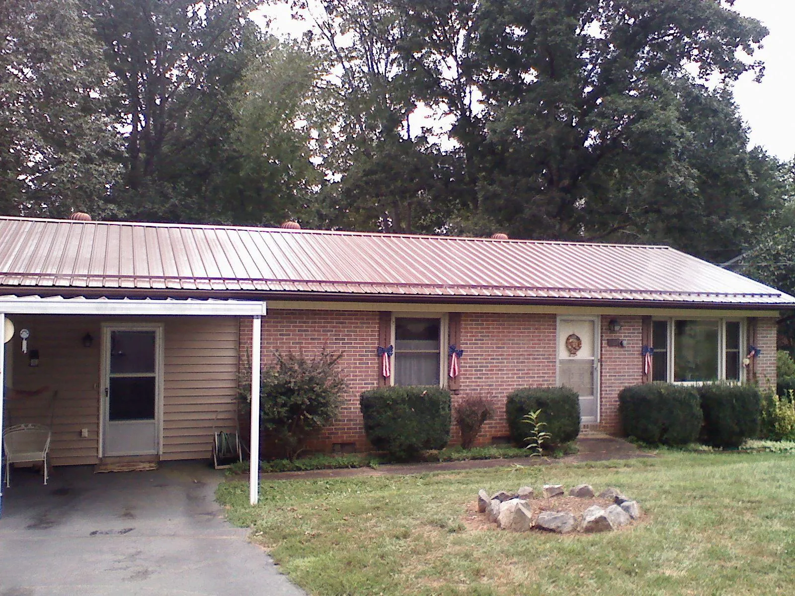 Bronze metal roof and carport on a brick ranch home — Roof Repair work by our crew in Elizaville
